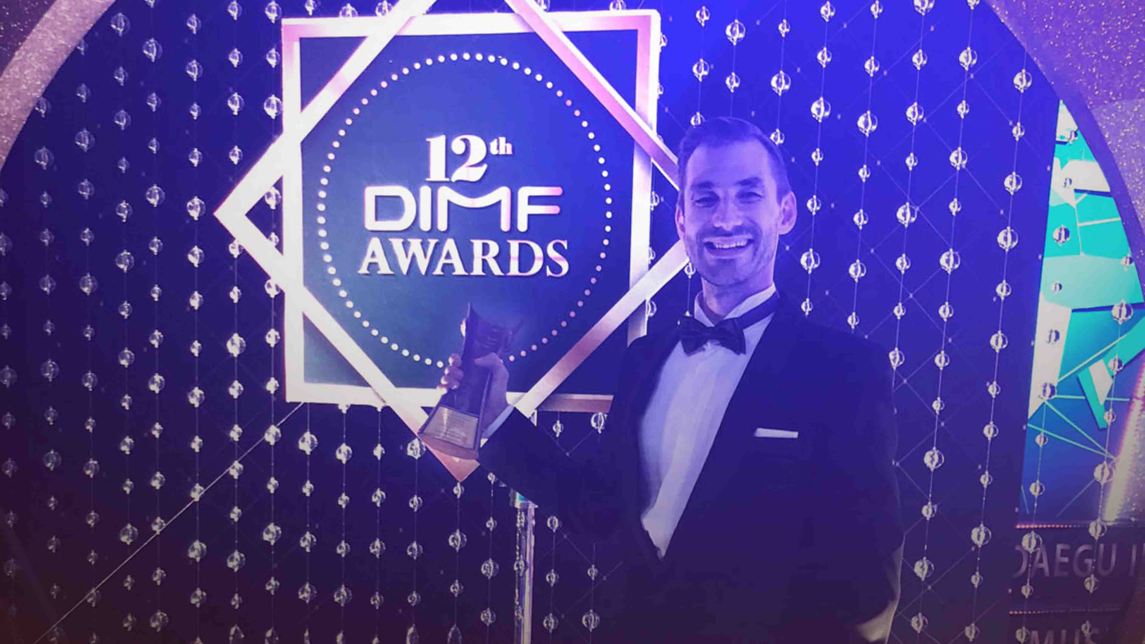 Daniel Barták holding the award for Best Leading Actor in a musical role from the DIMF musical festival